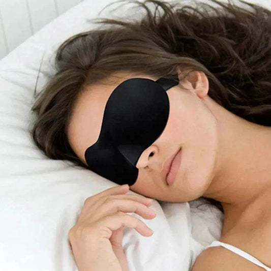 3D contoured sleep mask on a woman lying down, offering lightweight and adjustable 100% light blocking for restful sleep.