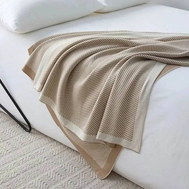 Beige Nordic Style Knitted Throw on bed showcasing reversible design and minimalist aesthetic.