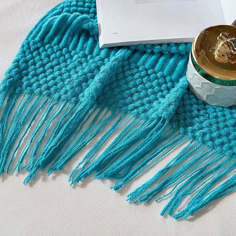 Knitted soft throw blanket with tassels in turquoise, part of 10 color options.
