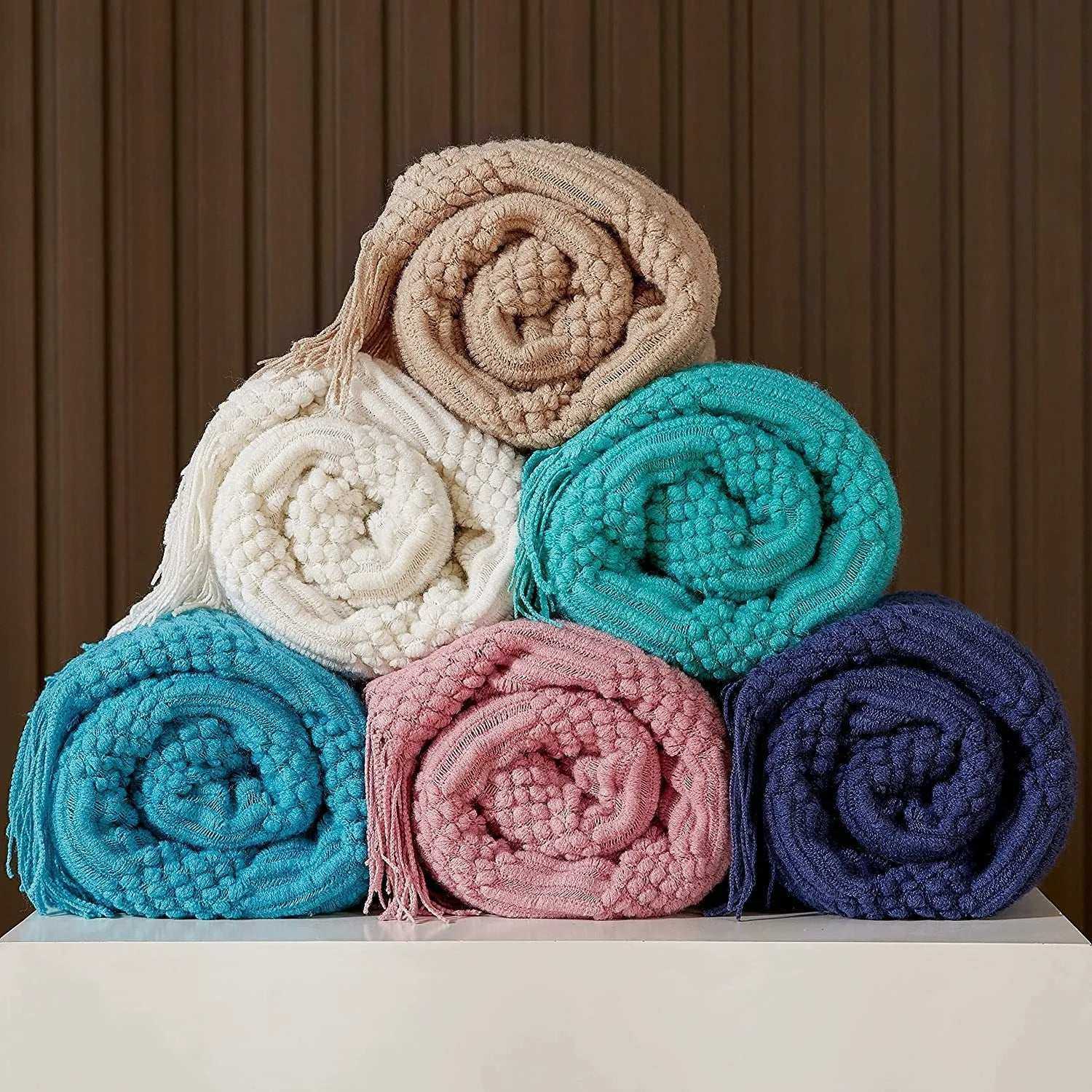 Knitted throw blanket with tassels, available in 10 colors, showcasing soft woven texture.