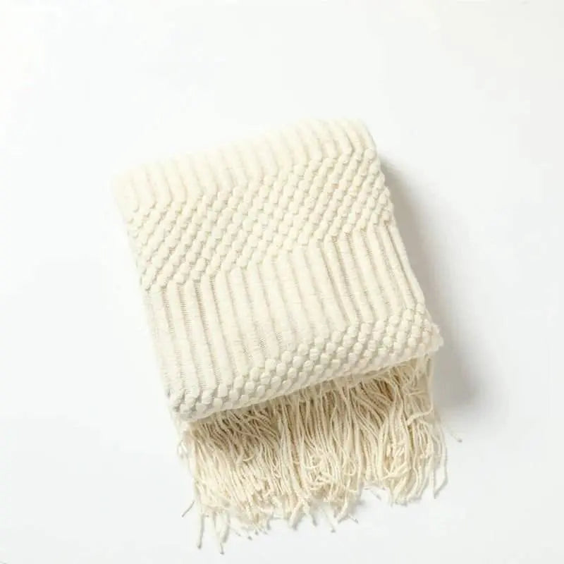 Knitted throw blanket with tassels, available in 10 colors, woven texture.
