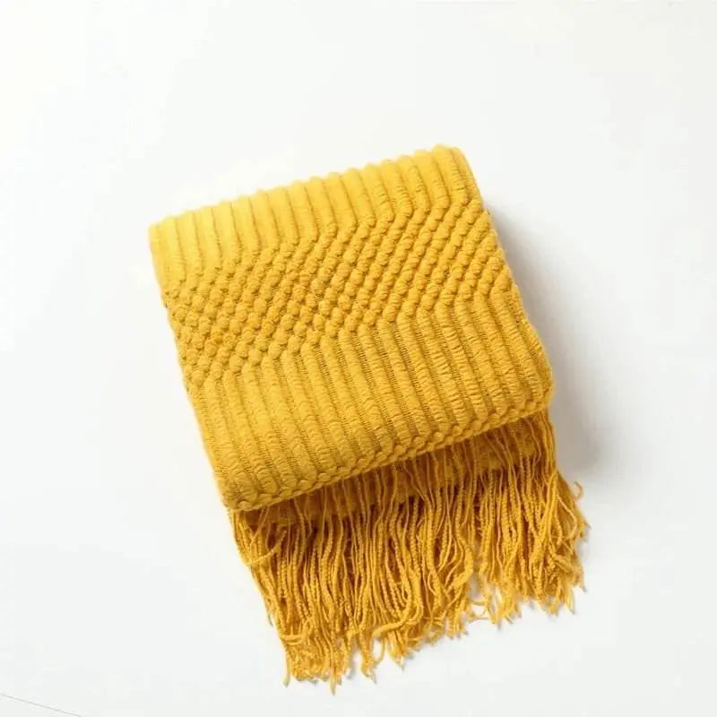 Knitted soft throw blanket with tassels in yellow, part of a 10-color collection; cozy and elegant acrylic fabric.