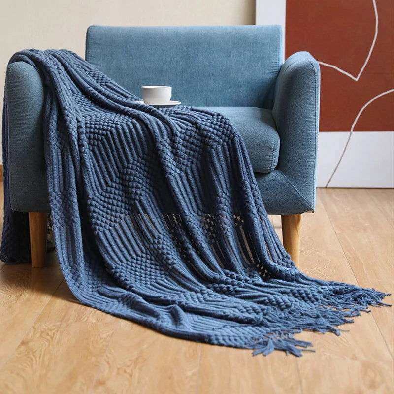 Knitted soft throw blanket with tassels in 10 colors, shown draped over a chair.