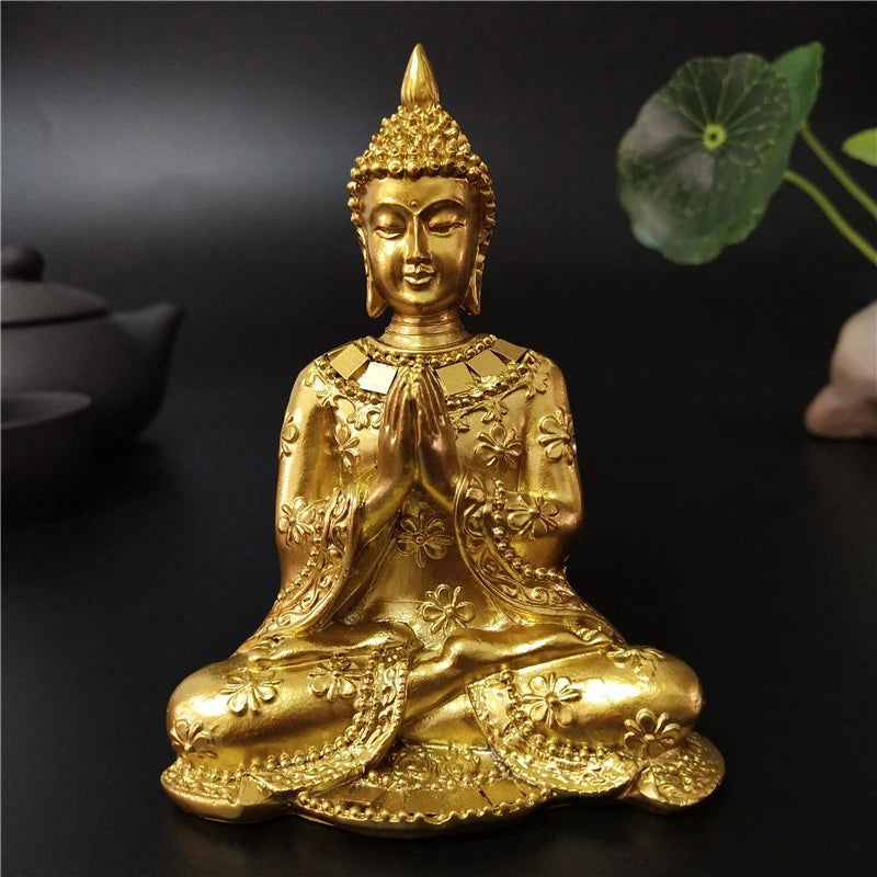 Seated Thai Buddha statue in gold finish depicting Anjali Mudra, symbolizing serenity and spiritual enlightenment.