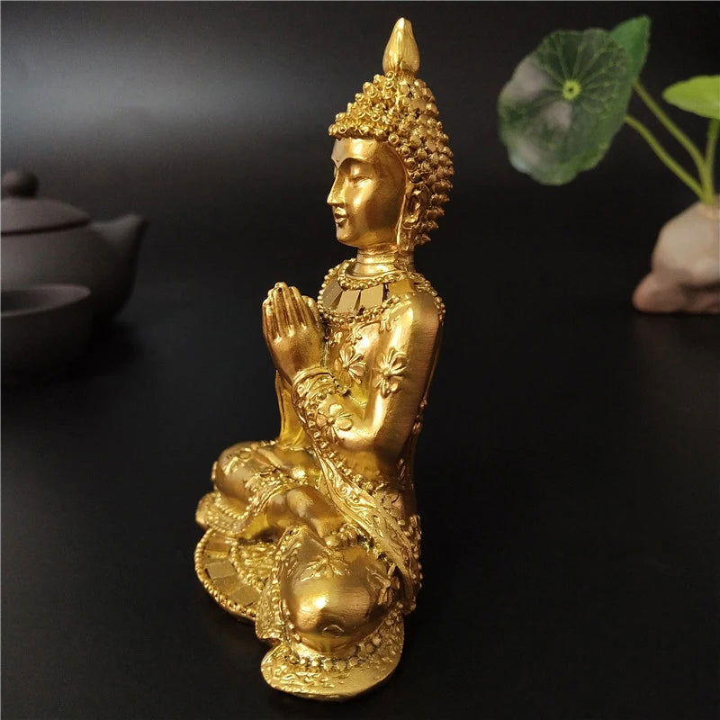 Gold Thai Buddha statue in seated pose with intricate details, symbolizing serenity and enlightenment.