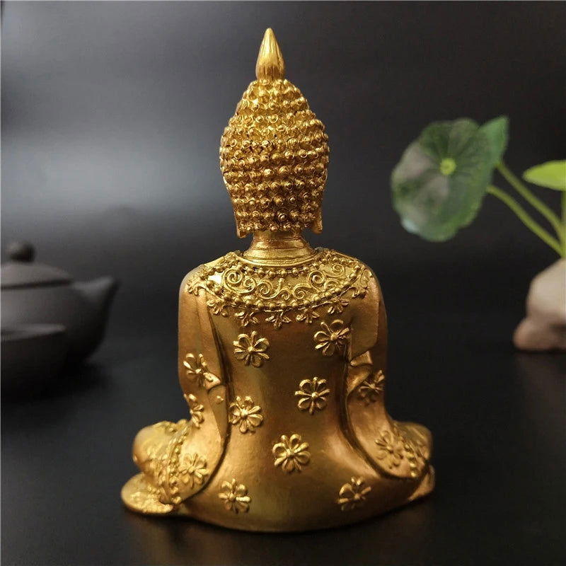 Seated Thai Buddha statue in gold finish, symbol of serenity and spiritual enlightenment.