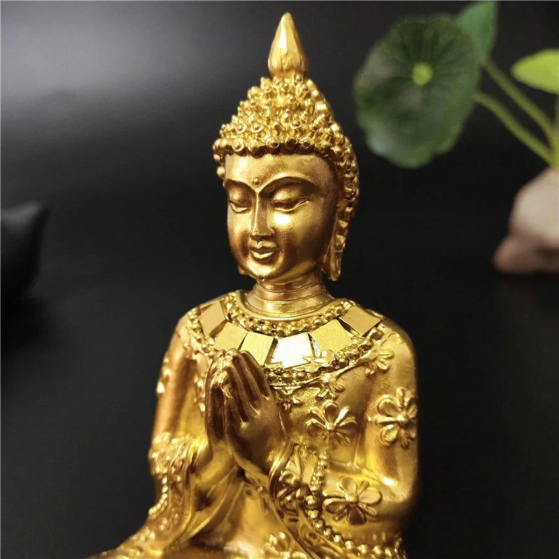 Seated Thai Buddha statue in gold finish with Anjali Mudra gesture, symbolizing serenity and spiritual enlightenment.