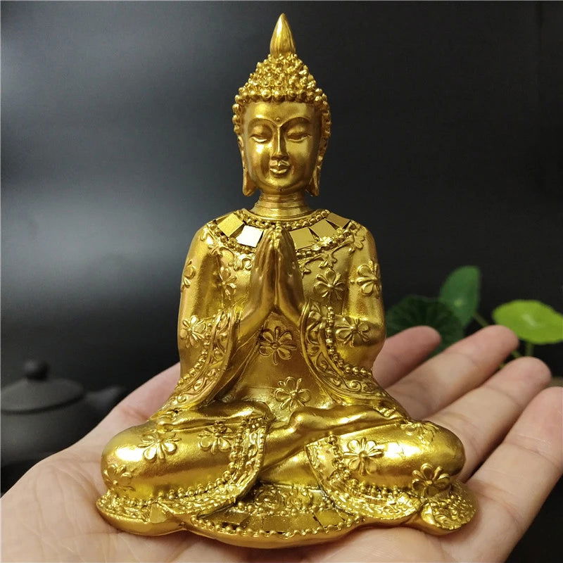 Thai Buddha statue in gold, representing Anjali Mudra, symbolizing serenity and spiritual enlightenment.