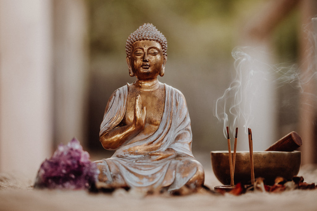 Buddha Seated with_ncence and singing bowl