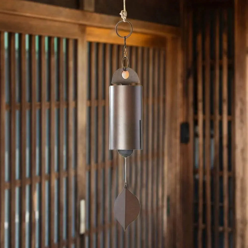 Metal wind chime with retro design and leaf pendant, available in two sizes, hanging outdoors.