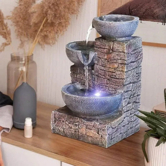 Soothing Fountain 3-tier Brick Tabletop with white light and flowing water on a wooden counter.