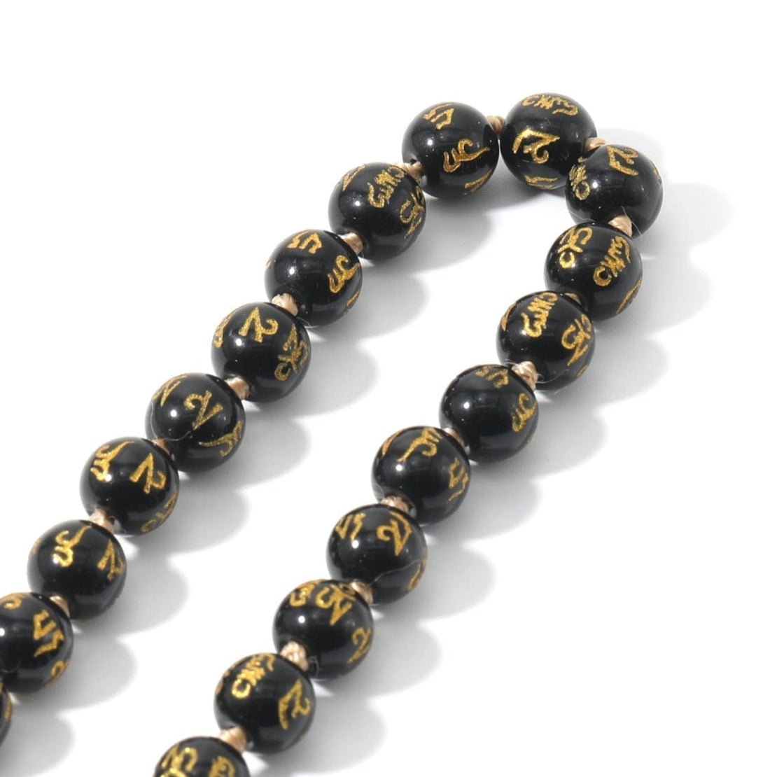 Black Onyx Mala, knotted with "Om Mani Padme Hum" Mantra engraved on each bead. - Serenity Factory