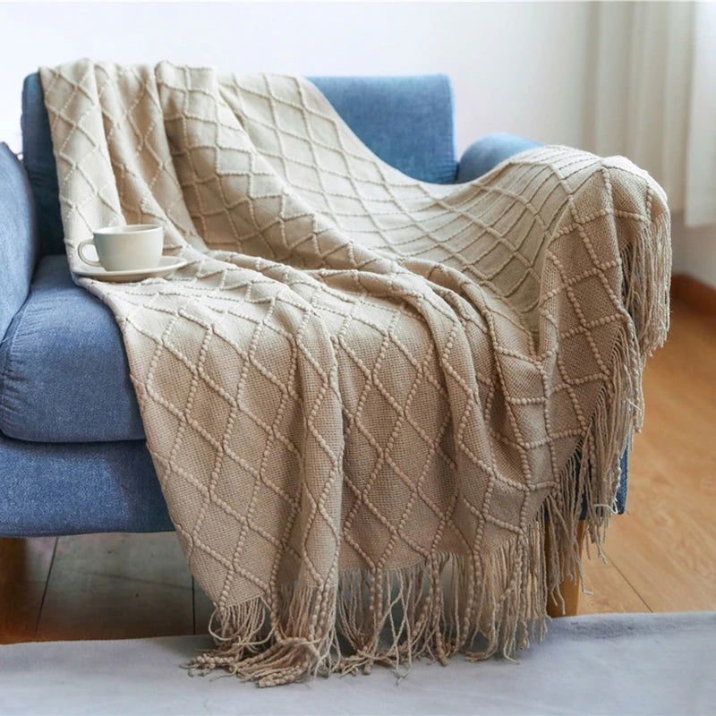 Cozy throw blanket on blue sofa, lightweight and soft.