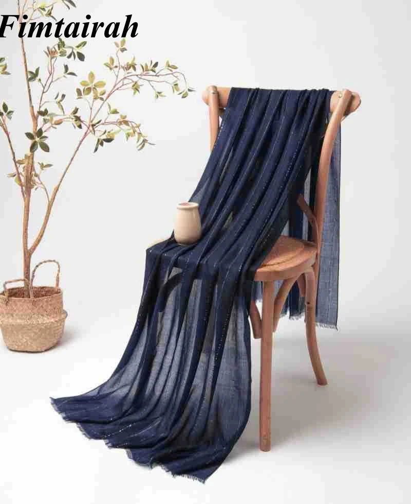 Luxurious 100% cashmere scarf draped over a chair, showcasing soft texture and elegant design.